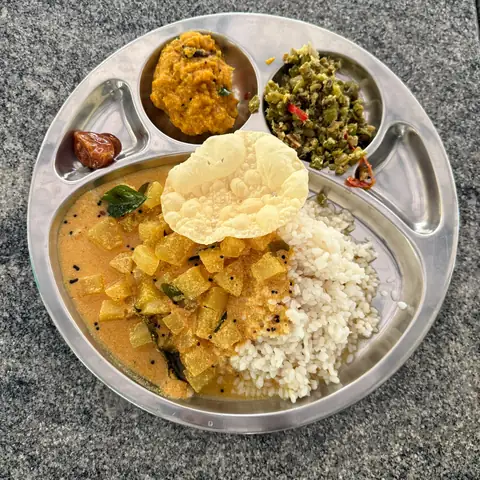 Attappadi-style vegetarian meal with rice, sambar, vegetables and papad